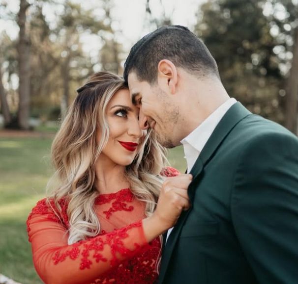 Alicia and Jason, foreheads together in golden autumn light