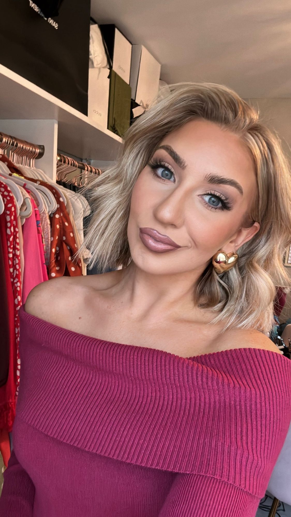 Alicia smiling in a bright pink sweater