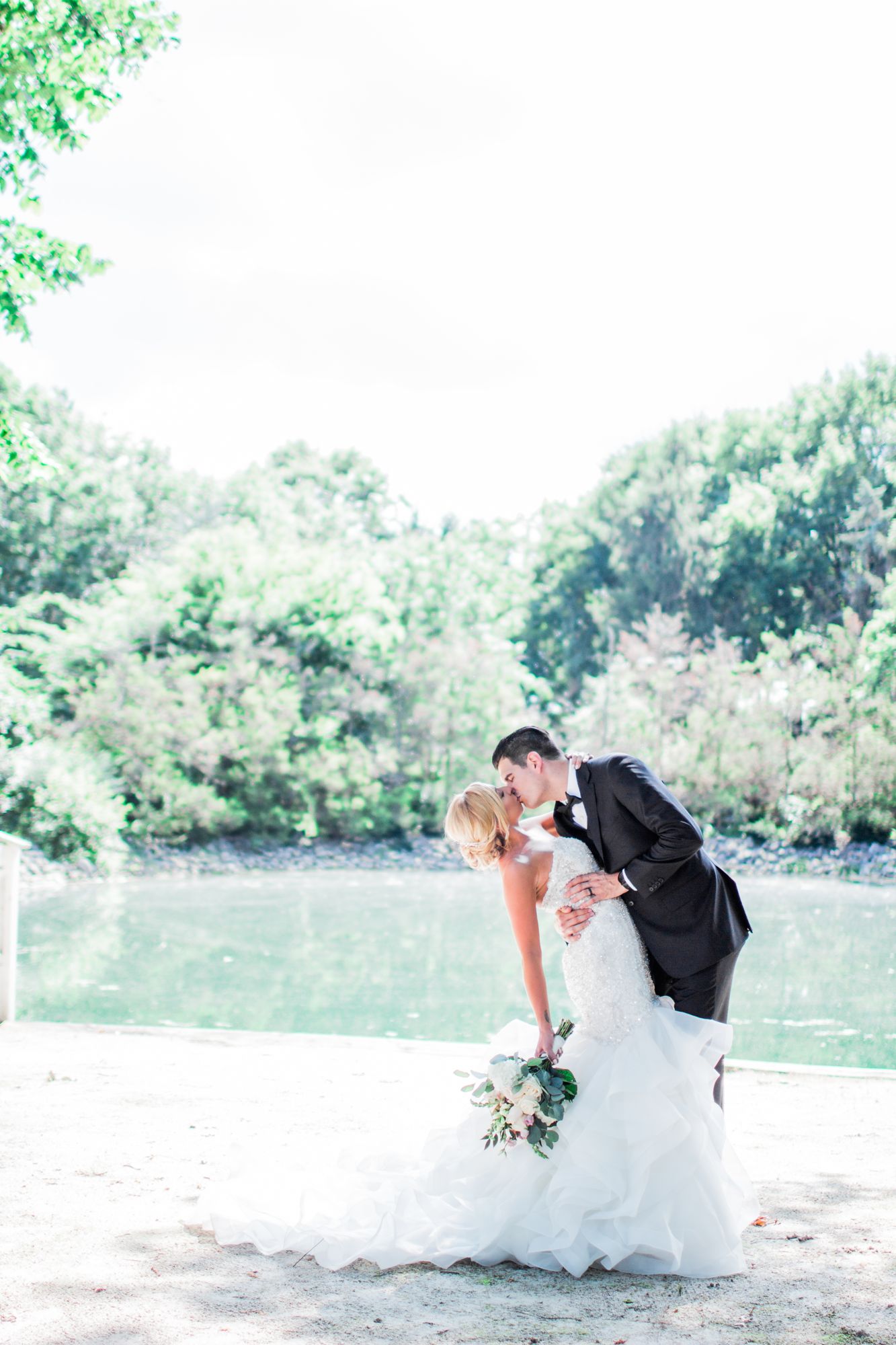 Alicia and Jason beside the lake on their wedding day
